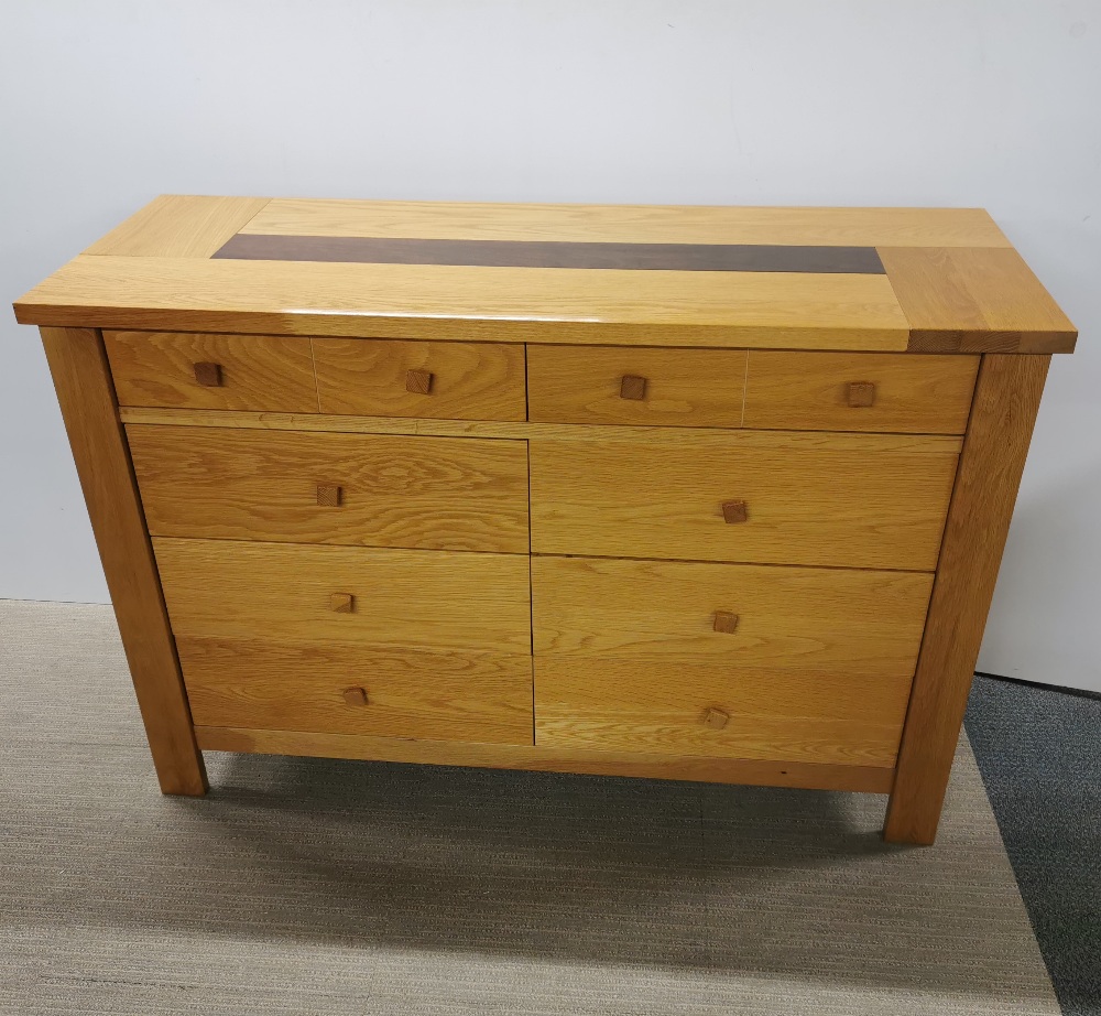 A heavy quality light oak eight drawer sideboard/ chest, 138 x 92 x 52cm.