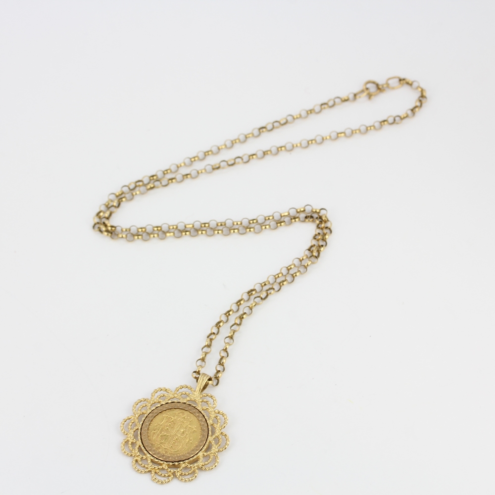 A hallmarked 9ct gold mounted half sovereign pendant on a 9ct gold chain, L. 56cm.