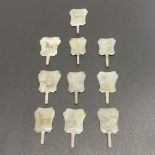 A fine set of ten Chinese carved mutton fat jade fan seals, H. 4.5cm.