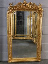 A large giltwood and gesso wall mirror with dual cherub decoration, 155 x 88cm.