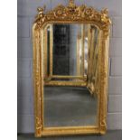 A large giltwood and gesso wall mirror with dual cherub decoration, 155 x 88cm.