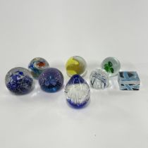 A group of eight paperweights, including a Caithness 'Cauldron Aqua'. H. 9cm.