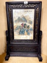 A Chinese hand painted porcelain and carved wood table screen, H. 68cm.