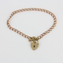 A 9ct gold bracelet with a heart padlock, internal L. 6.5cm.