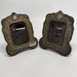 A pair of antique embossed white metal faced photograph frames, H. 23cm.