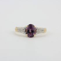 A hallmarked 14ct yellow gold ring set with an oval cut purple tourmaline and diamonds, (O).