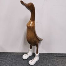 A large carved wooden amusing figure of a duck, H. 61cm.