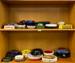 A large collection of vintage pub ashtrays.