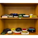 A large collection of vintage pub ashtrays.