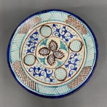 A hand painted pottery plate, Dia. 38cm, a/f.