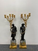 A pair of Empire style cast bronze and gilt candelabra on marble bases H. 69cm.