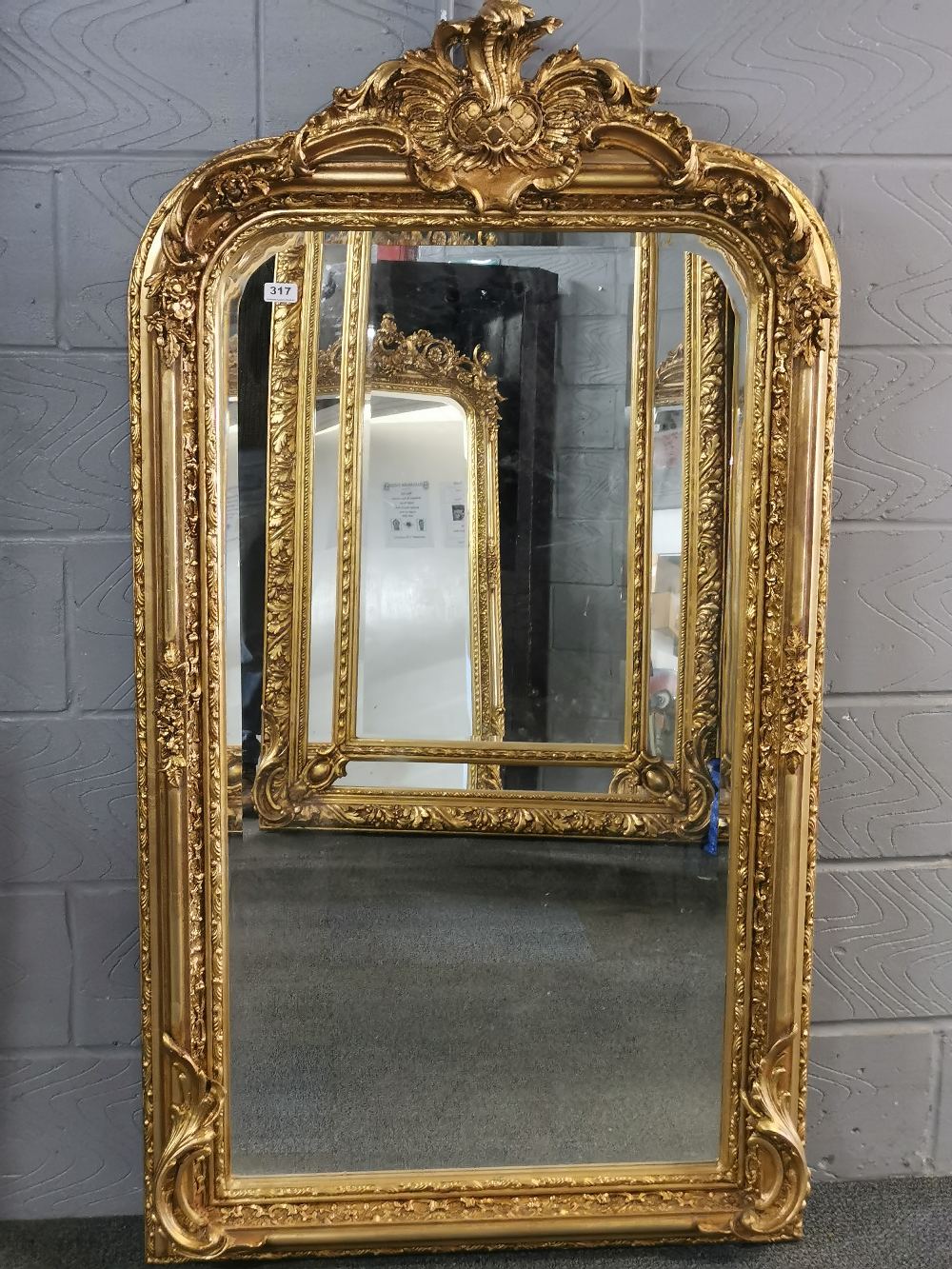 A large giltwood and gesso wall mirror, 158 x 88cm.