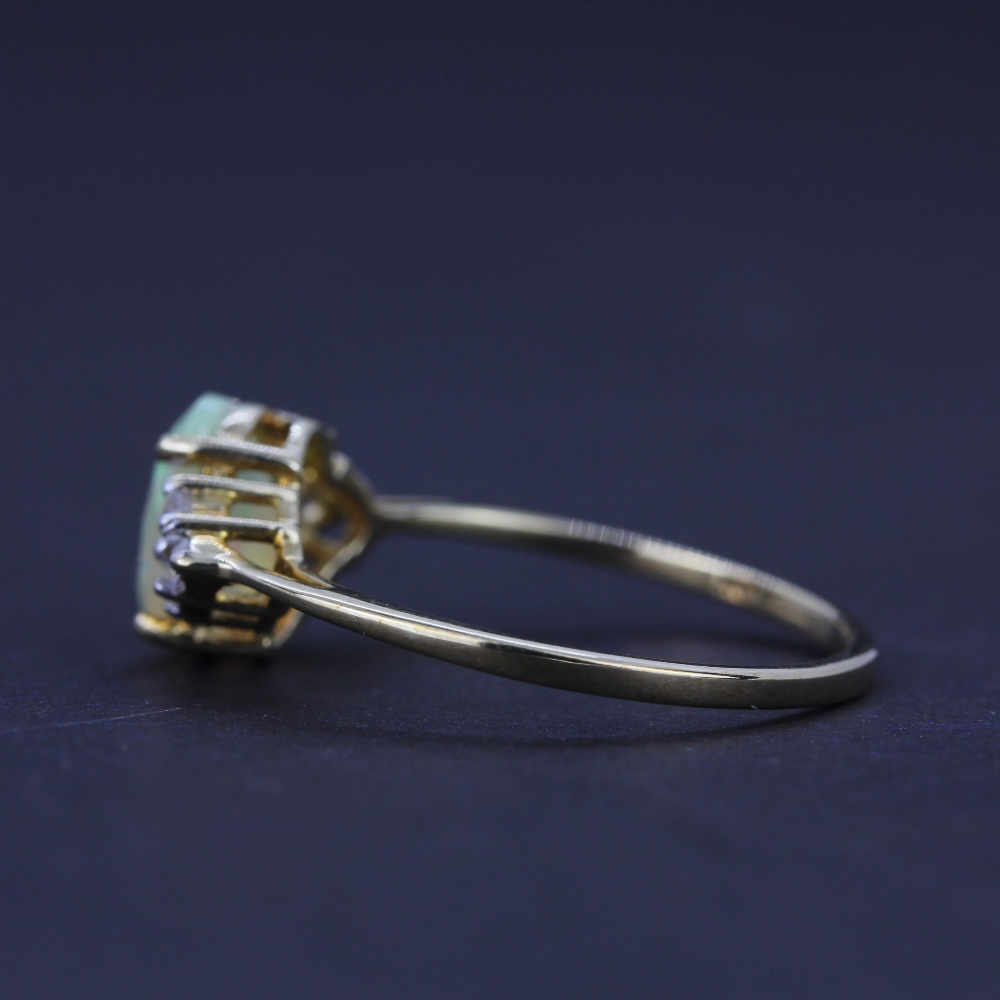 A 10ct yellow gold ring set with an oval cut opal and white topaz, (O), together with a pair of 10ct - Image 3 of 4