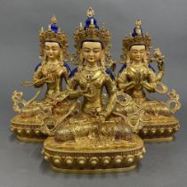 A group of three Tibetan gilt bronze figures of seated Bodhisatva with temple quality faces. H.