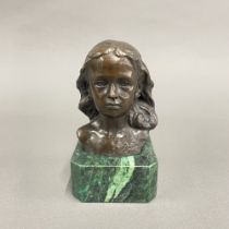 A small bronze bust of a girl on a heavy faux malachite base, H. 15cm.