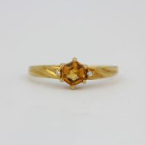 A hallmarked 18ct yellow gold ring set with an hexagonal cut citrine and diamonds, (O).