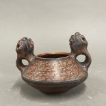 An early Eastern slip decorated pottery vessel with animal head handles, W. 15cm, H. 10cm.