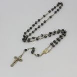 A white metal rosary necklace with haemetite beads, L. 49cm.