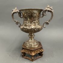 A 19th century heavy embossed silver two handled trophy (unengraved). H. 28cm. Standing on a Chinese