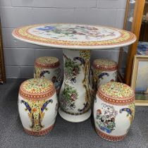 A Chinese ceramic garden table and four stools, table Dia. 89cm.