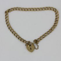 A 9ct gold bracelet with a heart padlock, internal L. 6cm.