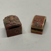 A Chinese carved soapstone double sided seal, together with a further carved soapstone seal,