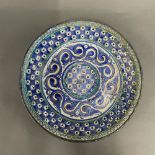 Islamic interest. A hand painted early north African pottery dish, Dia. 34cm.