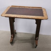An oak and leather adjustable architect's/ writing table on castors, largest size H. 115cm W. 86cm.