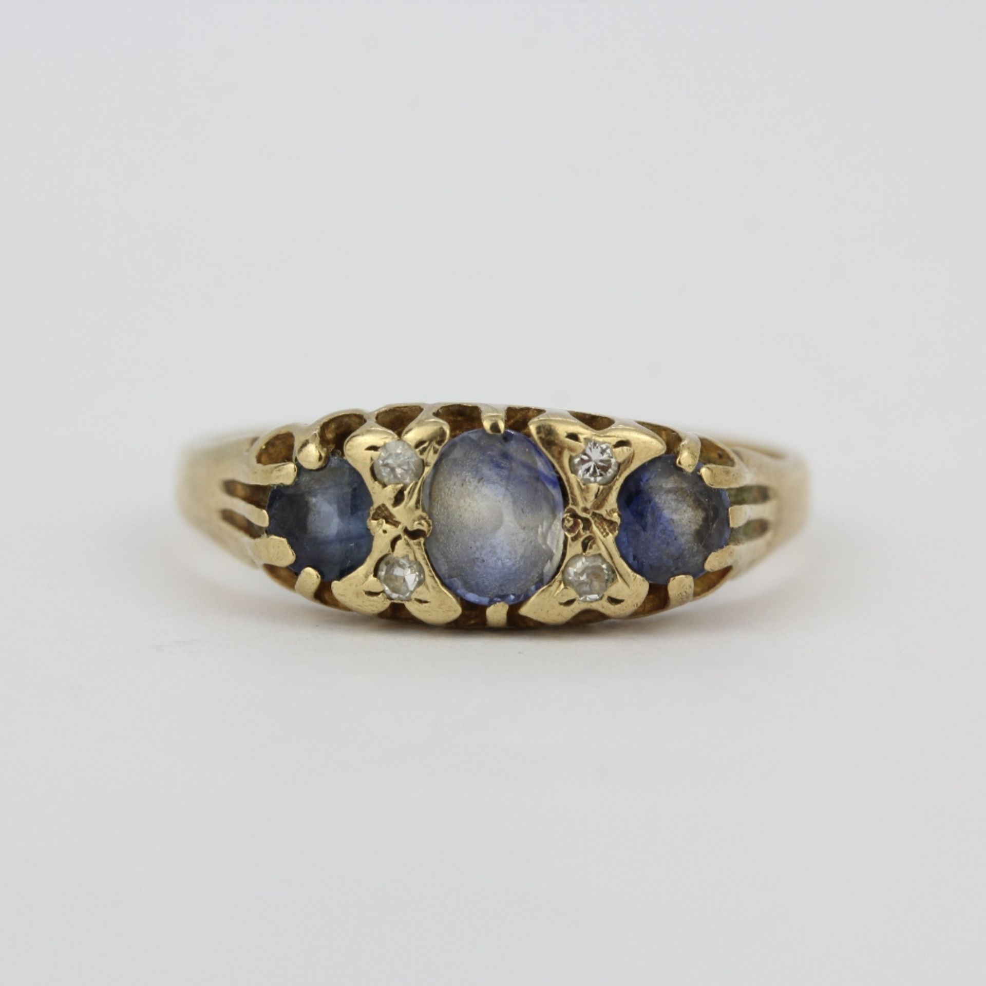 A yellow metal (tested minimum 9ct gold) ring set with ceylon sapphires and diamonds, (O).