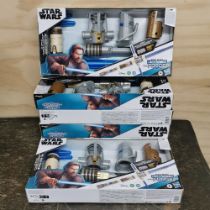 Six boxed Star Wars lightsabers.