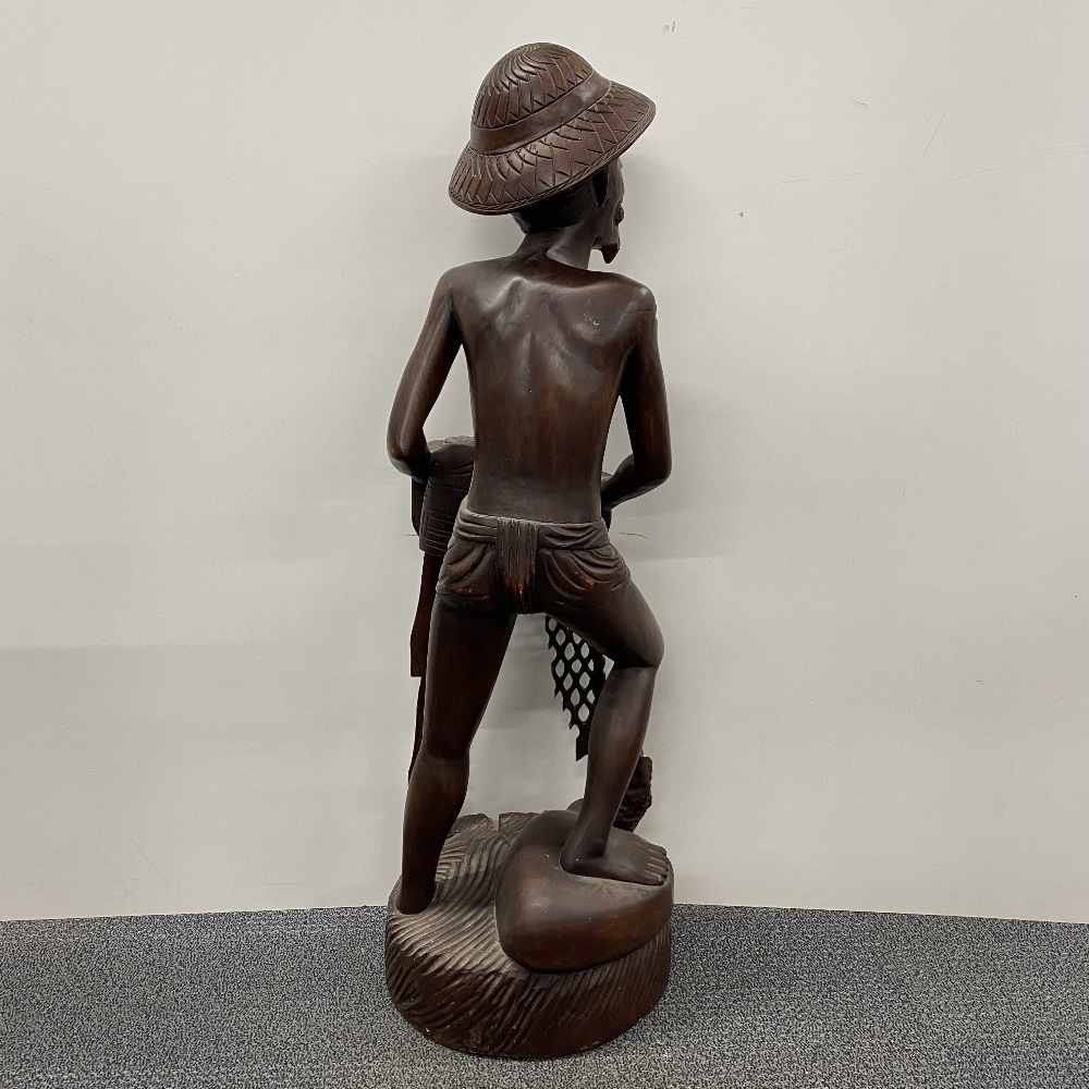 A large Eastern carved hardwood figure of a fisherman, H. 107cm, A/F. - Image 3 of 3