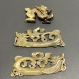 A group of three Chinese carved celadon jade / hardstone dragon items, longest 12cm.