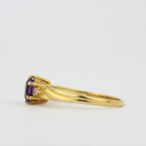 A hallmarked 18ct yellow gold ring set with a hexagonal cut amethyst, (O).