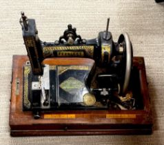 An inlaid cased Peerless sewing machine.