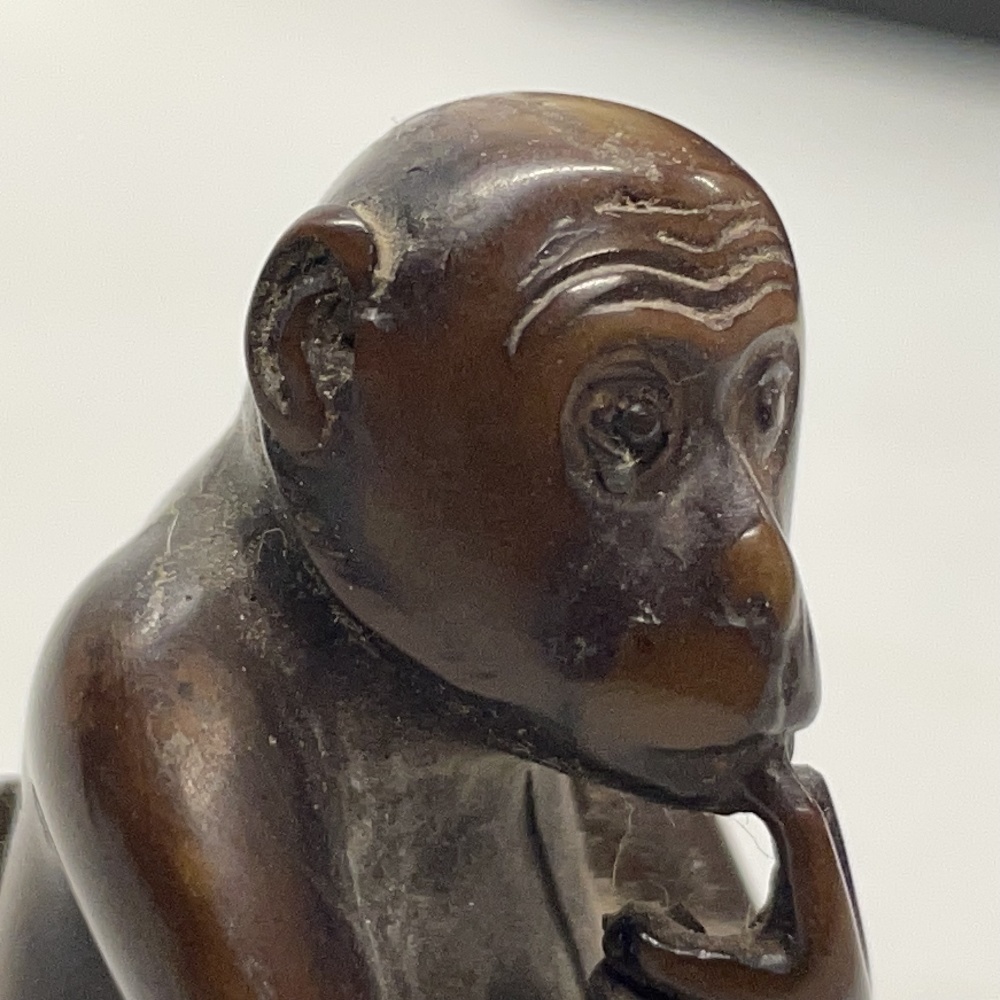 A Chinese carved wooden netsuke of a monkey, together with a further carved wooden netsuke of a cat, - Image 4 of 4