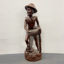 A large Eastern carved hardwood figure of a fisherman, H. 107cm, A/F.