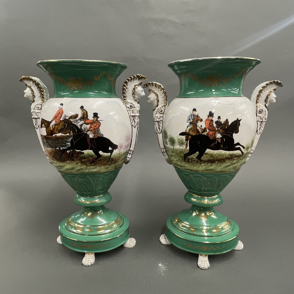 A pair of Continental porcelain vases featuring hunting scenes, H. 39cm.