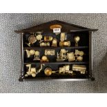 A cased collection of miniature clocks.