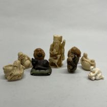 A group of Chinese bone, resin and tagua nut figures and netsuke, tallest H. 7cm.