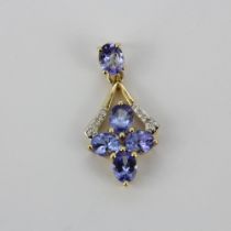 A 10ct yellow gold (marked 10K) tanzanite and diamond set pendant, L. 3.9cm.