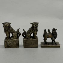 A pair of Chinese cast bronze seals decorated with liondogs, together with a further cast bronze