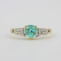 A hallmarked 18ct yellow gold ring set with a pear cut paraiba tourmaline and diamond shoulders, (