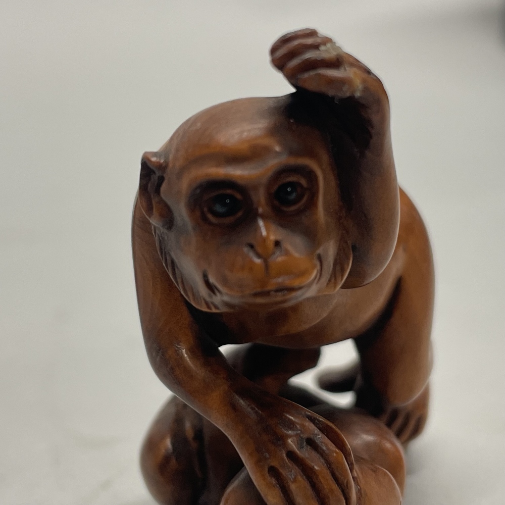 A Chinese carved fruitwood netsuke of a monkey on a branch, together with a further netsuke of two - Image 2 of 3