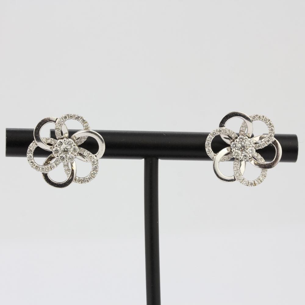 A pair of 18ct white gold flower shaped stud earrings set with brilliant cut diamonds, L. 1.6cm. - Image 2 of 4