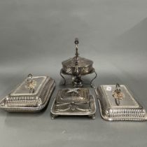 A silver plated kettle on stand, with a sardine dish and two silver plated tureens and covers.