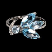 A 925 silver ring set with marquise cut blue topaz and white stones, ring size P.