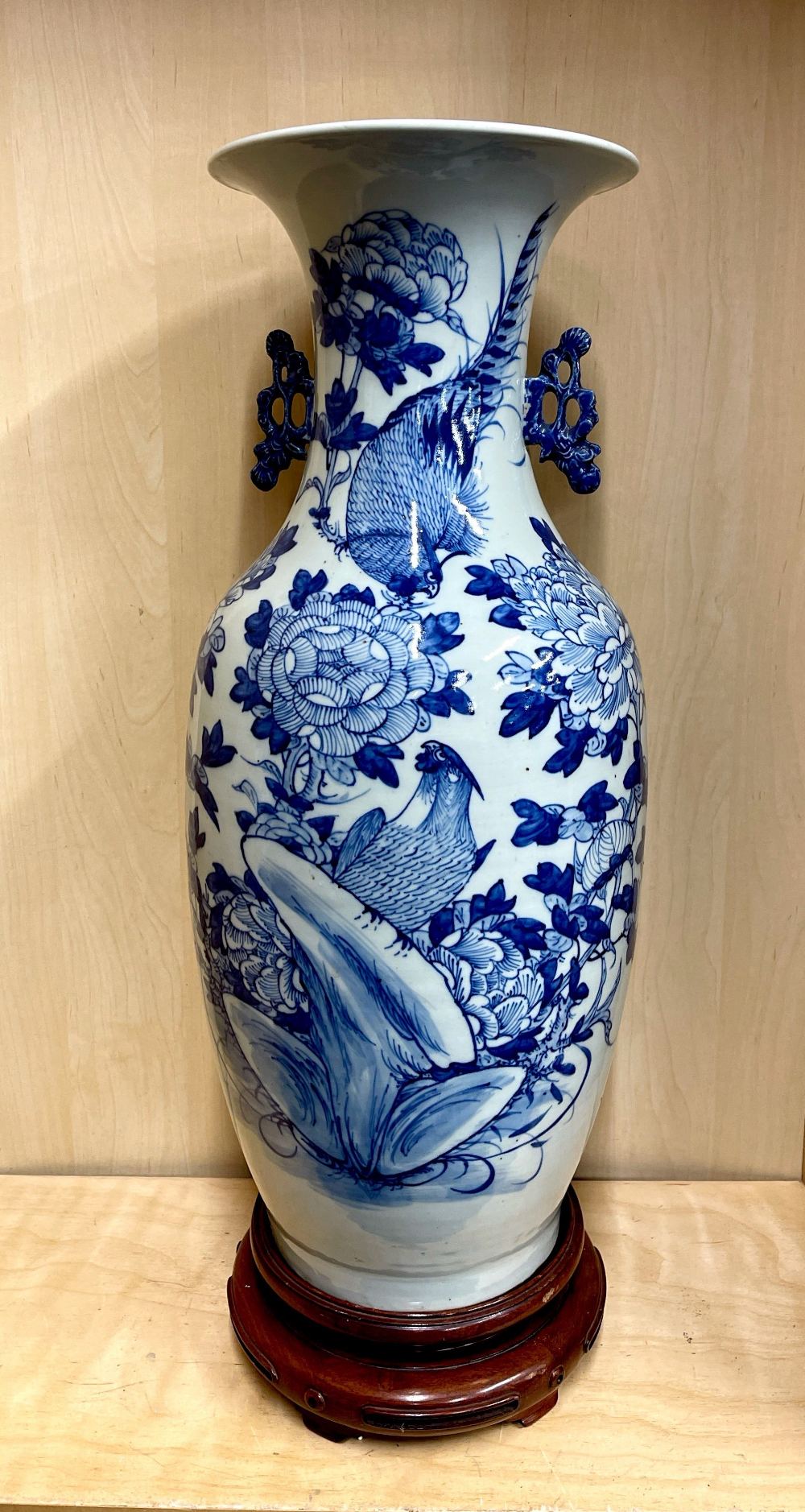 A large 19th / early 20th century Chinese hand painted porcelain vase with a turned wooden vase,