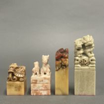 A group of four Chinese carved stone scholars' seals, tallest 12cm.