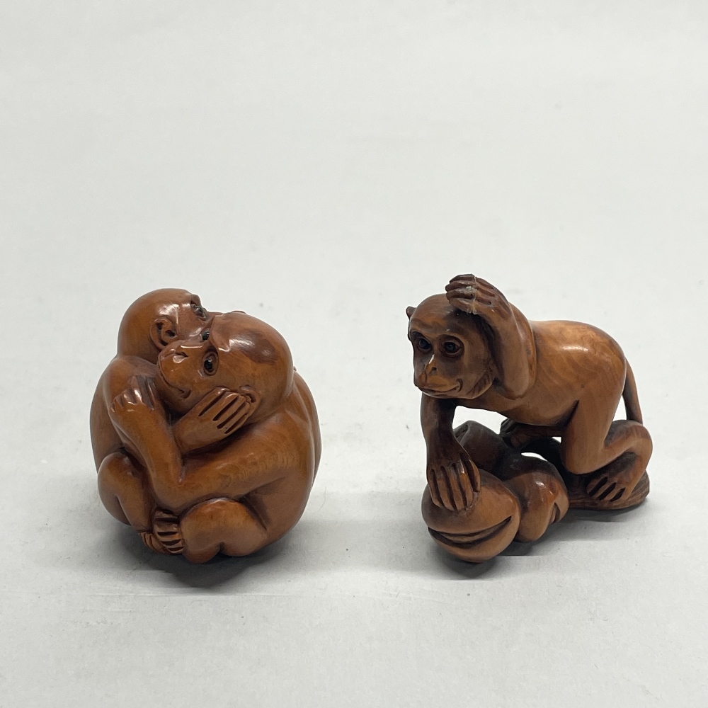A Chinese carved fruitwood netsuke of a monkey on a branch, together with a further netsuke of two