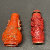 A Chinese carved coral snuff bottle, H. 7.5cm, together with a cinnabar snuff bottle.